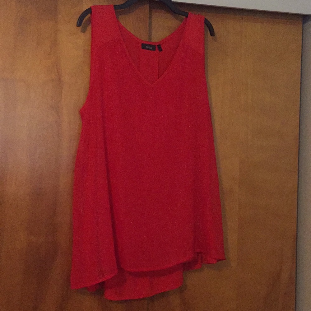 Red sleeveless tunic.